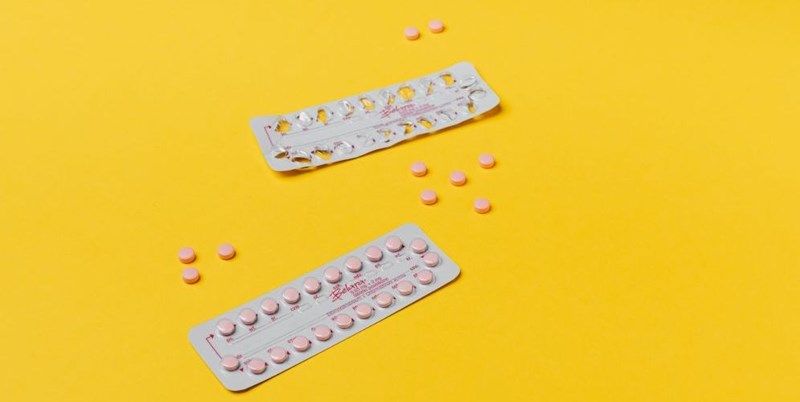 pink-pills-on-yellow-surface-40471081.jpg